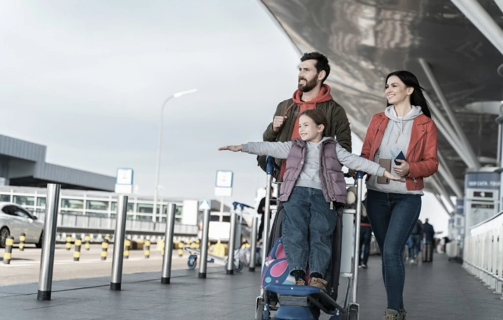family arriving in the airport waiting for their airport car service